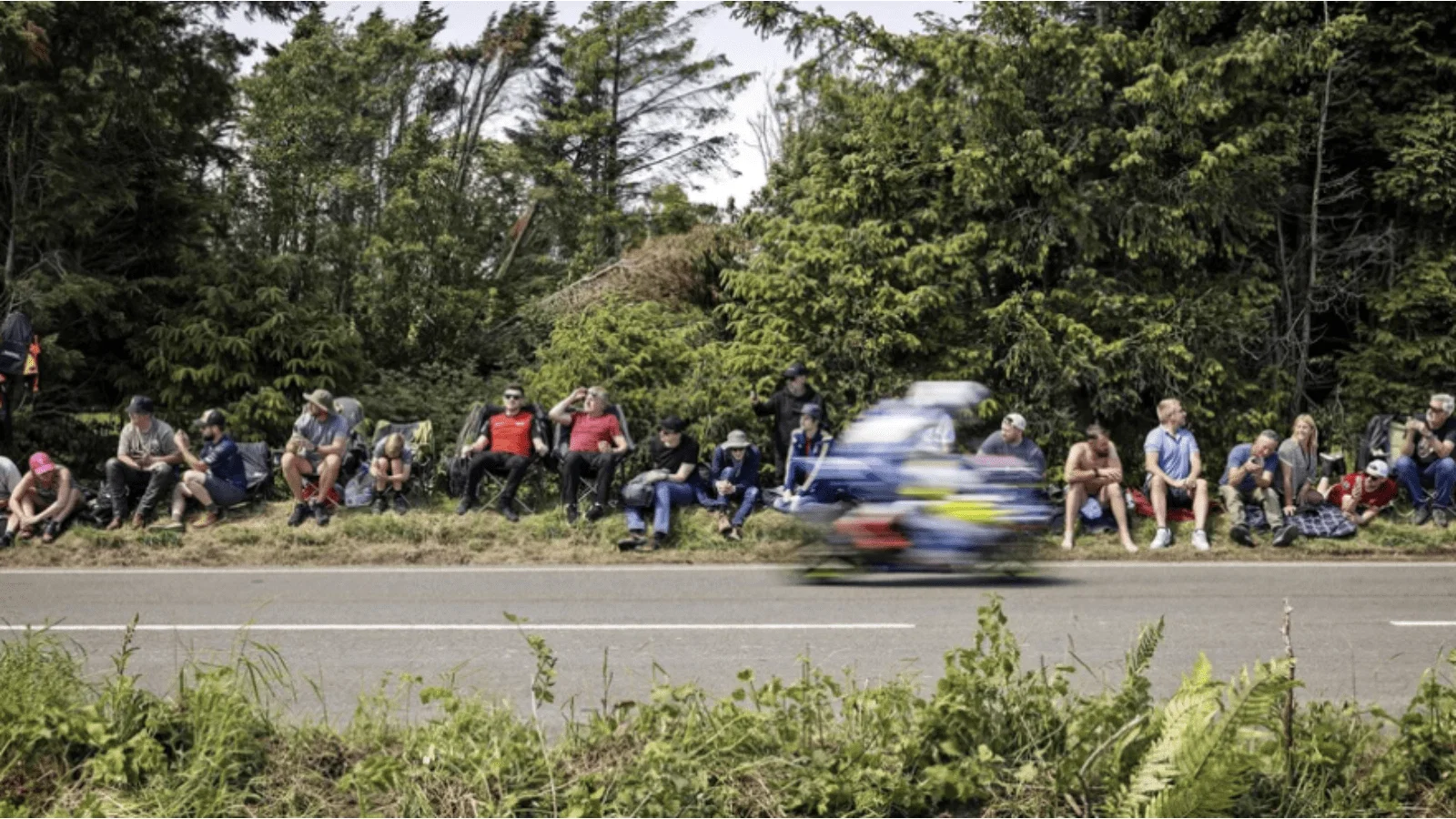 A rider flying past fans at the Isle of Man TT. Credit: Isle of Man TT.
