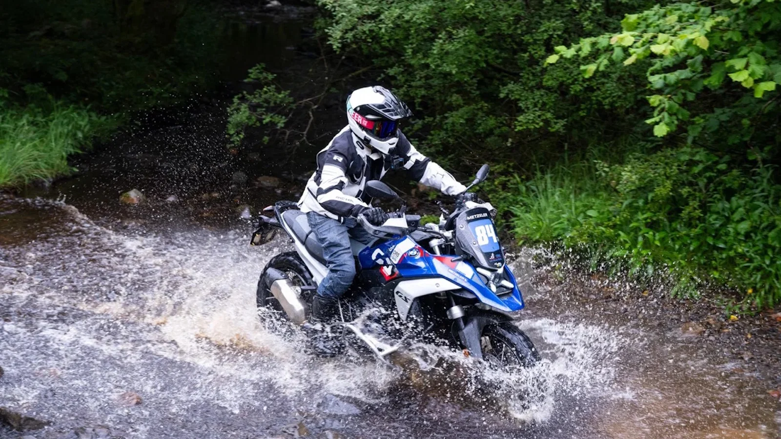 A BMW R1300 GS crossing a river